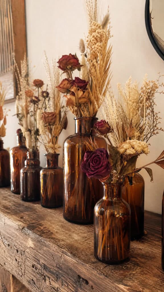Dried Flower Arrangements In Amber Glass Bottles